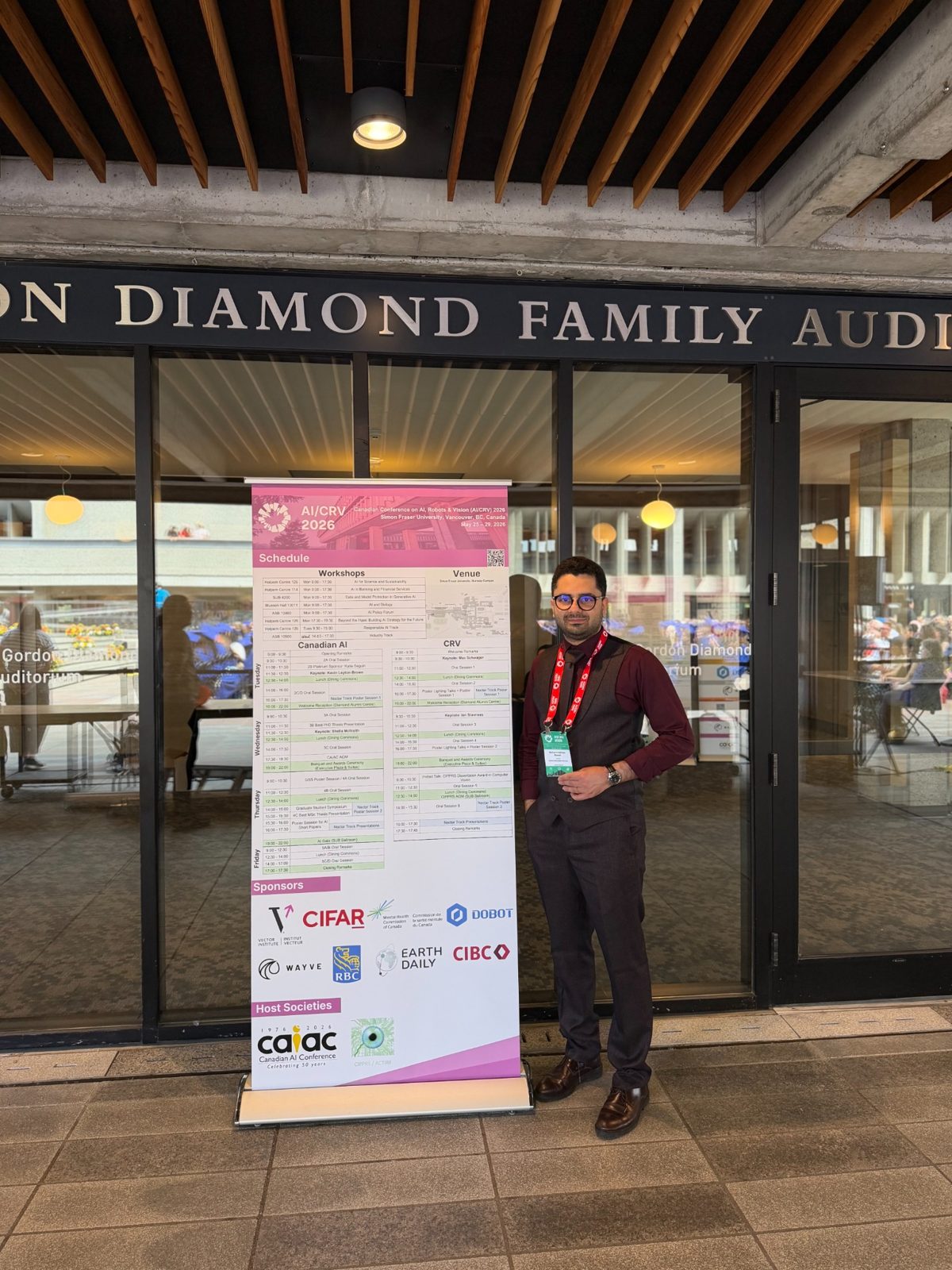 Mohammadreza Maleki beside the AI/CRV 2026 conference schedule at Simon Fraser University